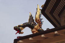 Sculpture Of Black Dragon With Golden Wings, Standing On The Edge Of Pagoda Roof In The Kew Gardens, London