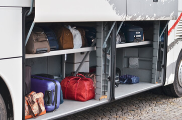 Suitcases in the luggage compartment of intercity bus. Selective focus. 