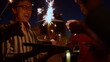 © stockbusters - People enjoying bengal lights birthday party. Friends having fun with fireworks