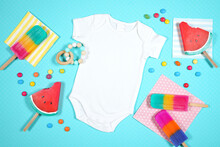 Summer Beach Vacation Theme Baby Romper Bodysuit Flatlay Styled With Watermelon And Ice Creams On A Blue Background. White Product Mock Up With Negative Copy Space For Your Text Or Design Here.
