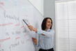 © New Africa - English teacher giving lesson near whiteboard in classroom