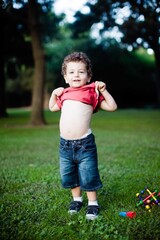 Little Boy Shows Belly in Park