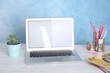 © New Africa - Modern laptop and stationery on white wooden table. Space for text