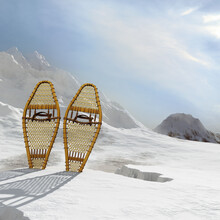 Winter Mountain Landscape Covered In Snow. Pair Of Snowshoes Upright In The Snow.