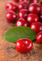 Wall Mural - Cherries on wooden table with water drops