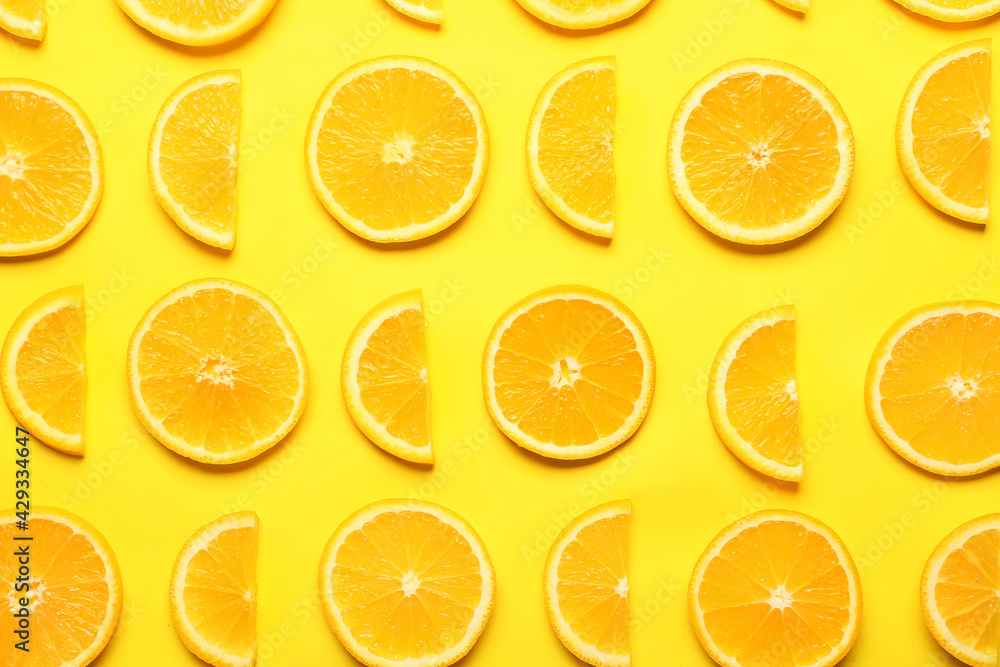 Slices of fresh oranges on color background