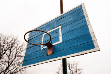 Old basketball hoop made of wood with a beautiful texture against the sky