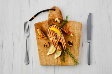 Wall Mural - Overhead view of raw trout steaks on wooden cutting board