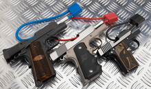 Gun Safety , Locked Disarmed And Secured Automatic Hand Guns On Metal Background