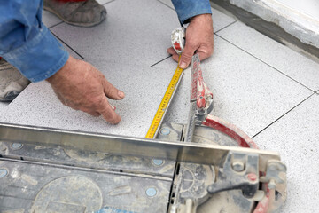 Professional ceramics tile man worker placing new tiles on the floor and wall.