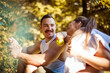 © liderina - Couple in the park having break and eating healthy meal. Salad and apple.