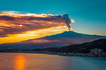 Wall Mural - Epic eruption of Mt Etna during sunset. Volcanic eruption by the sea