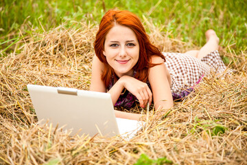 Wall Mural - Young  fashion girl with notebook lying at field