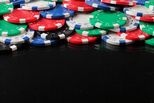 A Heap Of  Gambling Chips  On Black Background. Backdrop With Copy Space.