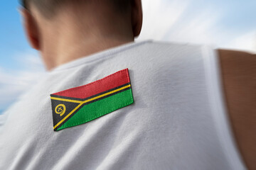 The national flag of Vanuatu on the athlete's back