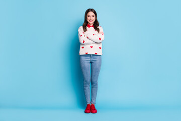 Sticker - Full length photo of adorable shiny young lady wear hearts print sweater arms crossed isolated blue color background