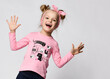 Portrait of excited funky girl wearing raglan with kitten print, headband screaming loudly laughing with open mouth showing palms to camera standing isolated on white studio background