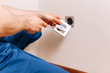 Fototapeta  - Electrician Installing a Nest in a New Home