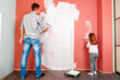 © Ruslan Ivantsov - father and daughter paint the wall in the room. home renovation