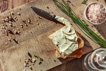 Wall Mural - Sandwiches on a wooden board with white cheese and chives