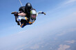 © Sky Antonio - Skydiving. Tandem jump. Man and woman in the sky.