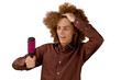 © Yuliia - A long-haired curly-haired guy in a brown shirt on a white background uses a metal round comb. Emotions before a haircut in a hairdresser