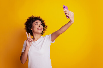 Content trendy cheerful nice cute adorable girl hold phone shoot selfie show v-sign