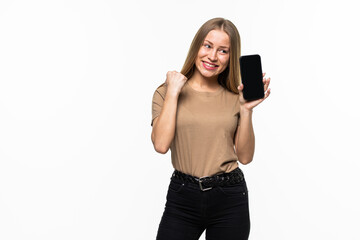 Young woman with a mobile phone celebrating a victory on white background