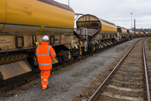 A Railway Worker Walking And Inspecting A Network Rail Goods Train For HS2