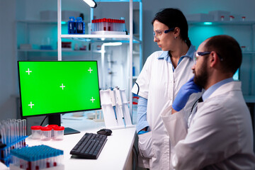 Wall Mural - team of scientist working and analyzing using computer with green screen in clinic, chemical special