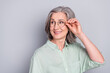 © deagreez - Photo of happy smiling dreamy mature businesswoman in glasses look copyspace isolated on grey color background