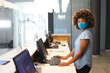 © Wavebreak Media - Portrait of woman wearing face mask working as receptionist in hotel