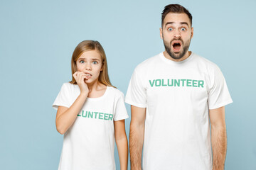 Two sad upset tired young friends couple teen girl man wears white tshirt green title volunteer isolated on pastel blue color background Voluntary free team work assistance help charity grace concept