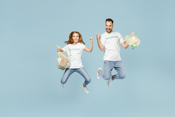 Full length two young friend couple teen girl man wear white tshirt green volunteer hold bag trash jump isolated on pastel blue color background Voluntary free team work help charity grace concept