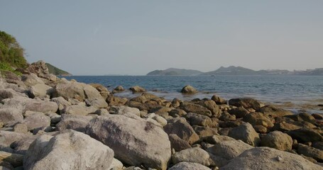 Wall Mural - Rock and stone beach with blue sky