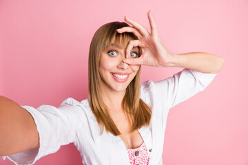 Poster - Photo portrait female blogger taking selfie showing okay gesture fingers near face smiling isolated on pastel pink color background