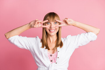 Poster - Photo of charming young girl demonstrate two v-signs cover eye wear white blouse isolated pink color background