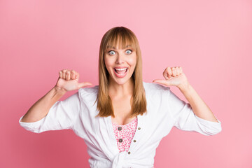 Wall Mural - Photo of young cheerful attractive woman happy positive indicate thumb herself proud victory isolated over pink color background