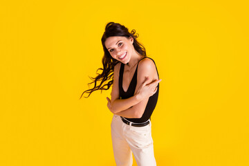 Wall Mural - Top above high angle view photo of young girl happy smile hug cuddle herself isolated over yellow color background