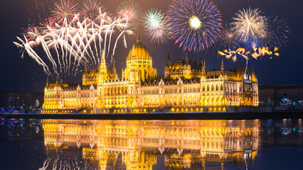 Wall Mural - Hungarian parliament with fireworks reflected in Danube river. Budapest