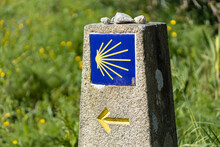 Camino De Santiago Sign On Stone Monolith With Green Grass Background