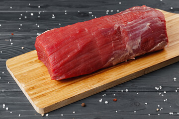 Wall Mural - Beef tenderloin on wooden board on wooden table