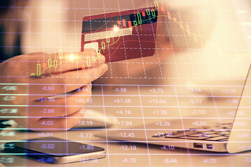 Multi exposure of woman on-line shopping holding a credit card and financial graph drawing. Stock market E-commerce concept.