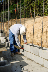 Wall Mural - Mason setting a concrete block wall