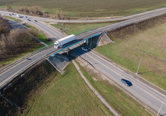 Wall Mural - Aerial Top View of White Truck with Cargo Semi Trailer Moving on