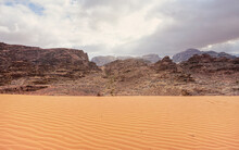 Rocky Massifs On Red Desert, Patterns On Small Sand Dunes In Foreground, Typical Scenery In Wadi Rum, Jordan