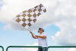 © Monika Wisniewska - Man waves a checkered flag