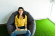© AntonioDiaz - Happy woman resting in a comfortable chair at work