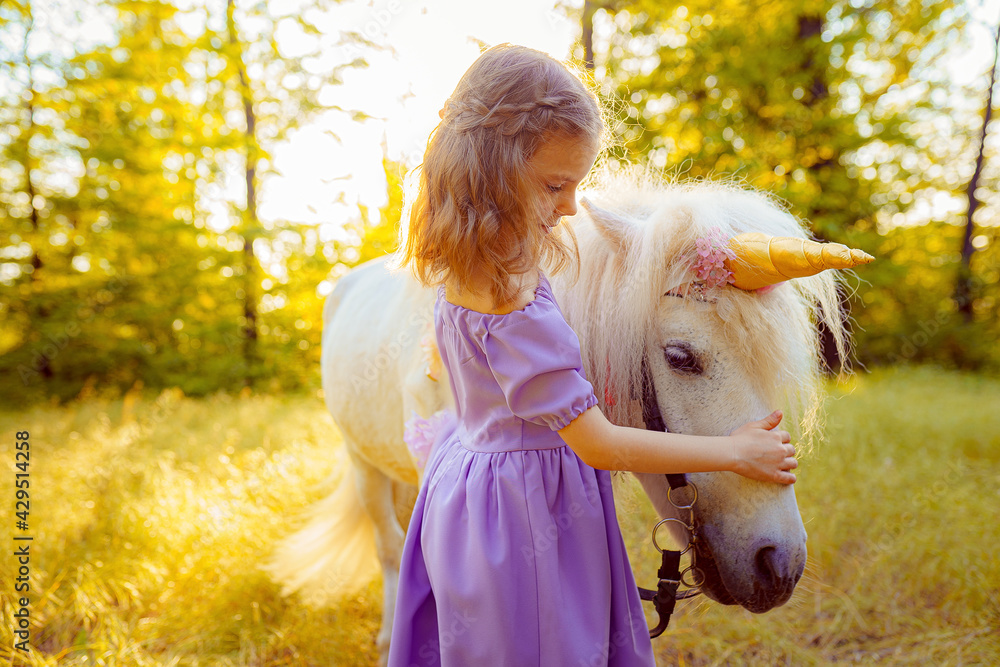 Girl in purple dress hugging white unicorn horse. Dreams come tr - obrazy, fototapety, plakaty 