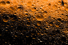 Orange Oily Substance That Has Water Droplets